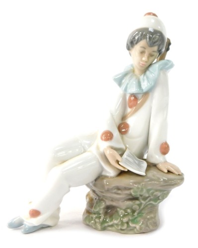 A Nao by Lladro figure of a seated clown, 17cm high.