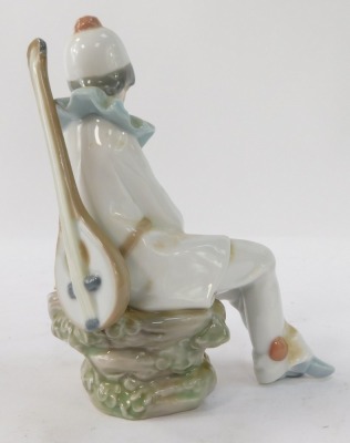A Nao by Lladro figure of a seated clown, 17cm high. - 2