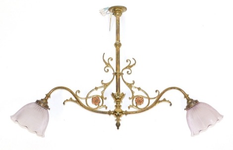 A Victorian brass electrolier, with two branches, with floral scroll detail, and two pink glass shades, 59cm high.