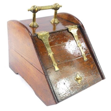 A late Victorian oak and brass bound coal scuttle, with coal, with reeded handle, brass buckle supports, bucket shaped, 40cm high, 32cm wide, 42cm deep.