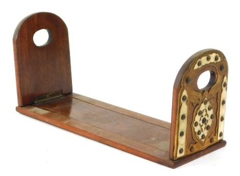 A Victorian mahogany adjustable book rack, with applied brass and bone ends, with sliding rule, 33cm wide, 12cm deep.