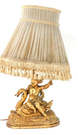 A gilt table lamp, of Putti Riding Swan, 41cm high. (AF) WARNING! This lot contains untested or unsafe electrical items. It is supplied for scrap or re-conditioning only. TRADE ONLY