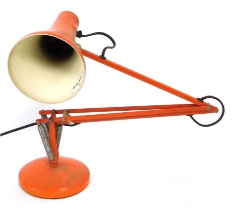 An orange Anglepoise desk lamp, 82cm high when fully extended.