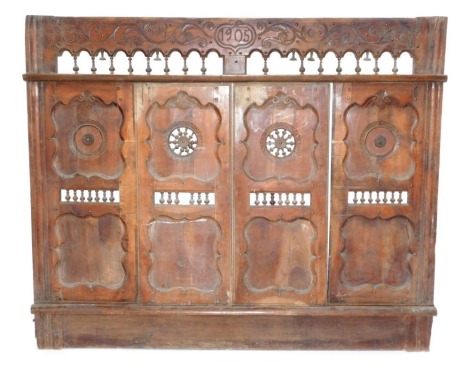 An Eastern wooden vanity or harem screen, with sliding doors and leather backed peep holes, 150cm x 180cm.