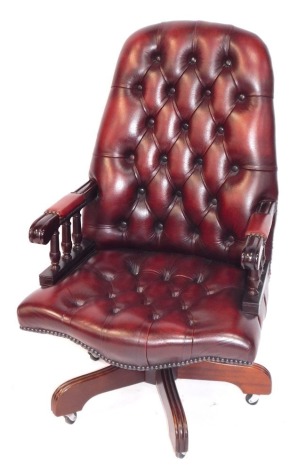 A ox-blood leather finish button back swivel office chair.