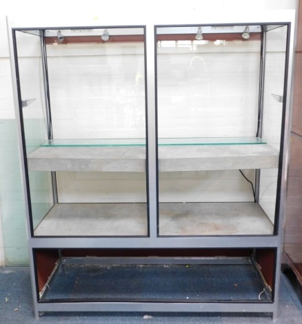 An aluminium framed and illuminated display cabinet, 180cm high, 150cm wide, 63cm deep.