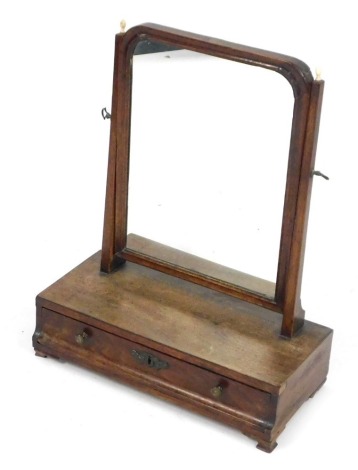 A 19thC mahogany swing frame mirror, the rectangular plate on square tapering supports, each with turned bone finials, the base with a single drawer on ogee bracket feet, 39cm wide.