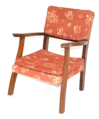 An oak child's open armchair, with loose padded back and cushion, on shaped front legs.