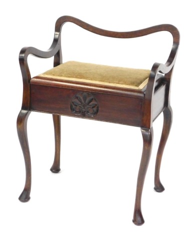 An Edwardian mahogany piano stool, with a shaped back and arms, hinged seat on cabriole legs with pad feet.