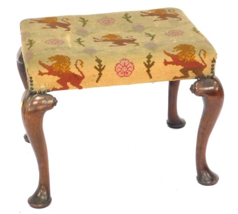 A walnut stool in 18thC style, with a woolwork padded seat, on cabriole legs with pad feet, 56cm wide.