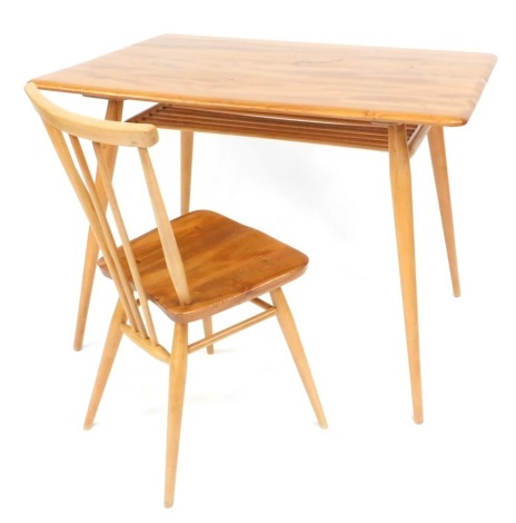 An Ercol light elm and beech desk, Model 393, the rectangular top with a spindle turned under tier, on turned tapering legs, 73cm high, 99cm wide, 68cm deep, together with a spindle back chair. (2)