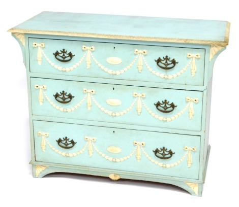 An early 20thC blue and white painted chest of drawers, the rectangular top with acanthus leaf border, above three drawers each with applied gesso swags in Wedgwood style, on bracket feet, 82cm high, 107cm wide.