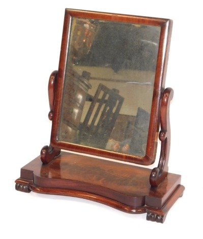 A Victorian flame mahogany dressing table mirror, with rectangular plate, scroll supports and serpentine stepped base, 55cm wide.