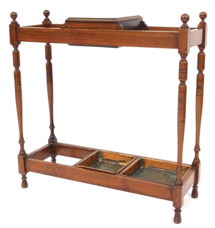 An Edwardian walnut stick stand, with lift top compartment and two (of three) copper trays, 68cm wide.