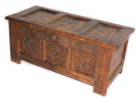 A 17thC oak coffer, with plain top, demi lune carved frieze, three panel carved front, raised on stiles, 45cm high, 102cm wide, 45cm deep.