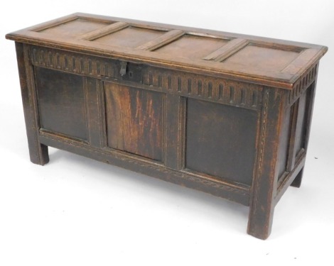 A late 17th/early 18thC panelled oak coffer, the frieze carved with flutes on stiles, 64cm high, 125cm wide, 51cm deep.