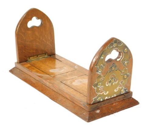 A 19thC Gothic oak bookslide, with arched ends and applied brass detail, 35cm wide, 16cm deep.