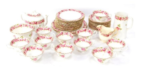 A Royal Doulton part tea service, decorated with pink roses with gilt border, HB7114/ES5070, comprising teapot, milk jug, large jug, eleven tea cups, sugar bowl, ten saucers, twelve side plates and two serving plates.