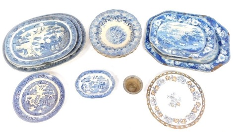 A group of blue and white wares, comprising a set of three graduated Willow pattern meat plates, large graduated meat plate and others decorated in the Game Keeper pattern, soup bowls decorated in the Vignette pattern, tureen plate, etc. (a quantity)