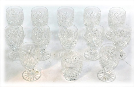 A set of twelve Waterford Crystal port glasses, each with cross checked decoration and stamped to foot, 11cm high, and a whiskey tumbler. (13)