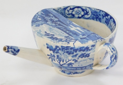 An early 19thC blue and white invalid feeder, decorated with a pastoral landscape 7cm high, 11cm wide.