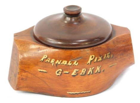 An early 20thC wooden box formed from an aeroplane propellor hub and root, painted Parnall Pixie G-EBKK, with a matched lid, 10cm high, 18cm wide.