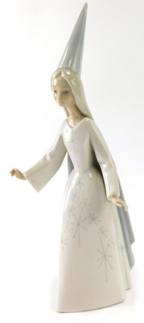 A Lladro figure of a female wizard, 27cm high.