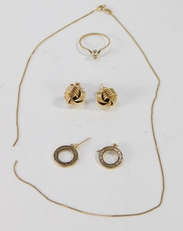 A group of scrap gold, comprising a pair of 9ct gold knot earrings, a pair of 9ct gold circular disc earrings, yellow metal chain unmarked, and a yellow metal dress ring, set with a tiny diamond, 7.1g all in. (a quantity)