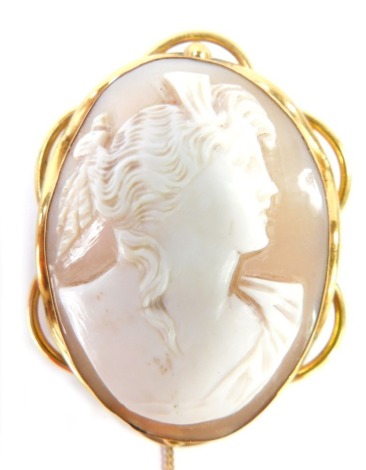 A 19thC shell cameo brooch, the cameo with raised relief figure of a maiden in gilt scroll border, 5.5cm x 4cm.