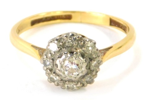 An 18ct gold diamond dress ring, with raised cluster with diamond set in illusion setting, stamped 18ct plat., size P ½, 3.3g all in.