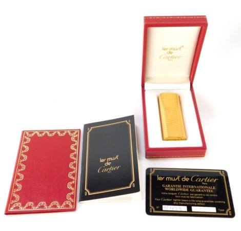 A Must de Cartier cigarette lighter in presentation case.