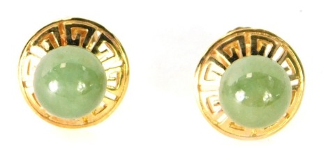 A pair of 9ct gold and dark green jade earrings, each of circular design with outer Aztec border, 4g all in, boxed.