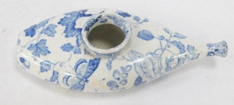 A 19thC blue and white baby feeder, floral leaf pattern, 17cm diameter.