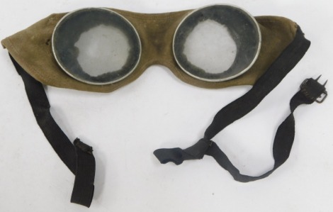 A pair of aviation glasses, on grey band support, 21cm diameter.