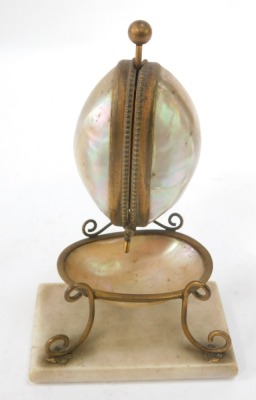 A 19thC French mother of pearl and brass Palais Royale watch stand, the two capped shell top with bowl on a rectangular foot, 16cm high, 10cm wide, 7cm deep.