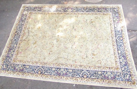 A European rug, cream ground decorated centrally with wild animals, birds and flowers, within a blue border decorated with birds and flowers, 328cm x 234cm.