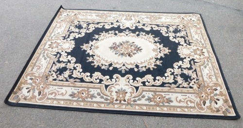 A green ground floral pattern machine made rug, 160cm x 160cm.