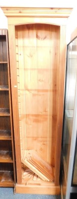 A stripped and waxed pine narrow open bookcase.