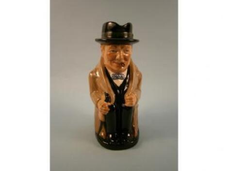 A Royal Doulton Toby jug in the form of a seated Winston Churchill