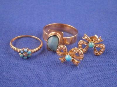 A yellow metal dress ring set with a cluster of five turquoise coloured stones