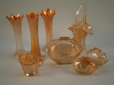 An orange tinted Carnival glass money boxes