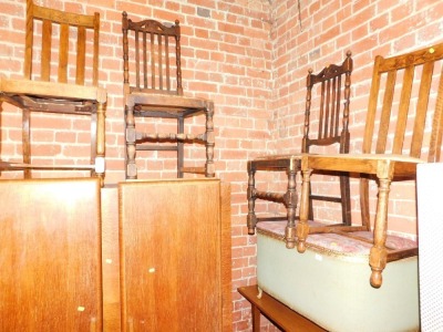 A green basket weave blanket box, and two oak dining chairs.