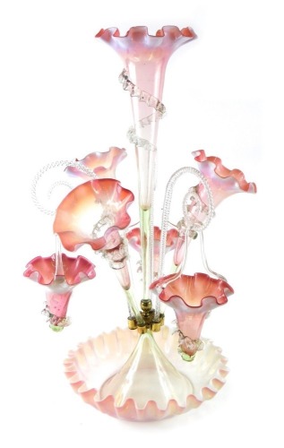 A Victorian pink and white opaque epergne, with three trumpet shaped vases and scrolls suspended with tapering baskets, 59cm high.