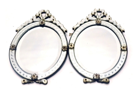 A pair of Venetian glass wall mirrors, each with engraved decoration, surrounding a bevelled plate (AF), 62cm high, 41cm wide.