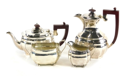 A harlequin silver four piece tea and coffee service, by Blackensee & Sons Ltd, etc., comprising coffee pot with wooden knop and angular handle, 24cm high, teapot, two handled sugar bowl and milk jug, Chester 1904 and Birmingham 1973, etc., 49oz all in. (