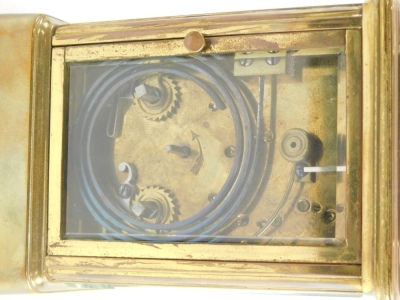 An early 20thC brass repeating carriage clock, in rectangular case with back plate, Roman numeric dial, on stylised bracket feet, in a five part glazed case with plain plate back, key wind barrel movement, and repeat button, 13cm high, in outer case. - 3