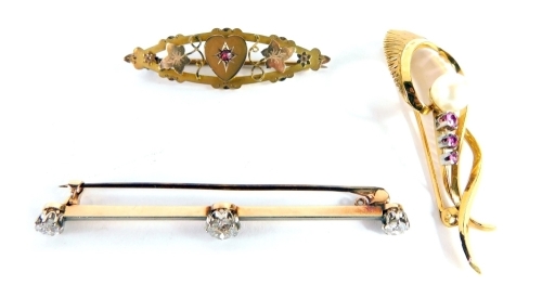 A Victorian bar brooch, set with three old cut diamonds, a ellipse brooch centred with a heart, inset with a small pink stone flanked by ivy leaves, in yellow metal marked 9 carat, 4cm long 2.2g all in, a further floral brooch, set with pearl and pink sto