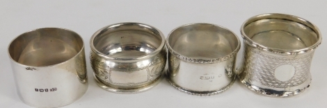 Four various George V silver napkin rings, Birmingham 1923 and others, 3cm high, etc., 3.24oz. (4)