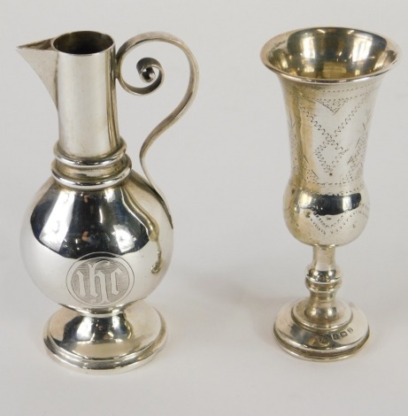 A Victorian silver travelling communion jug, by Jones & Willis, with S scroll handle, beak spout, bulbous body and circular foot, London 1872, and a silver miniature vase, 3.5oz. (2)