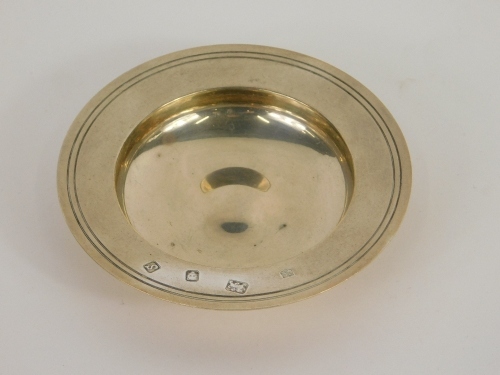 An Elizabeth II silver miniature armada dish, by William Comyns & Sons, of circular form with raised centre, London 1973, 10cm diameter, 3oz.